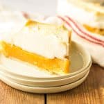 Slice of butterscotch pie with meringue on a small plate.