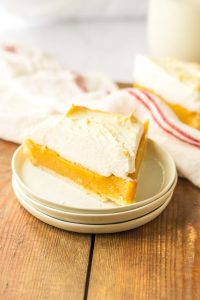 Slice of butterscotch pie with meringue on a small plate.