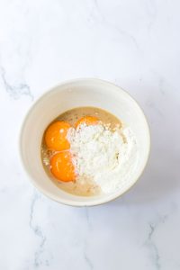 Bowl with egg yolks and cornstarch mixture ready to whisk.
