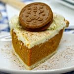 Gingerbread pie slice on a white plate with a festive background.