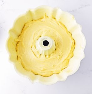Creamy batter smoothed evenly in a greased Bundt pan.