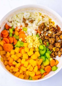 Chopped carrots, celery, onion, garlic, and browned sausage in a large pot.