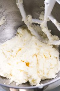 Stand mixer bowl with creamed butter and sugar.
