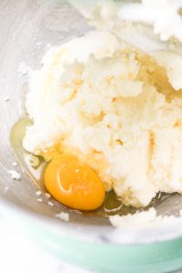 Egg added to creamed mixture in mixer bowl.