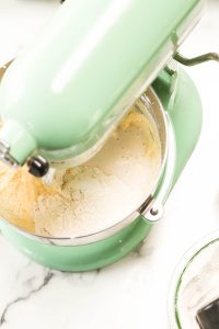 Flour and milk added to batter in stand mixer.
