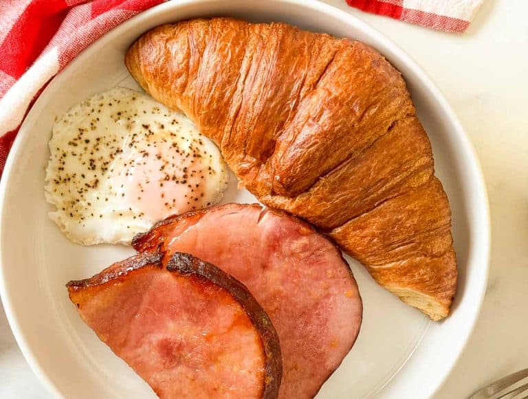 Ham steaks, croissant and egg in a blte.