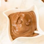 Thick homemade chocolate pudding topped with chocolate chips.