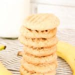 Peanut Butter Banana Cookies stacked on a plate with bananas.