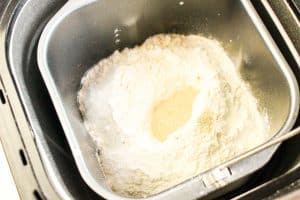 Bread machine pan filled ingredients ready for mixing.