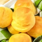 Very close view of golden brown sweet potato rolls with soft, smooth tops.