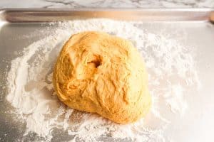Dough turned out onto a floured surface, ready to be shaped.