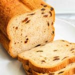 Close-up of a slice of cinnamon raisin bread highlighting the soft texture and raisins.